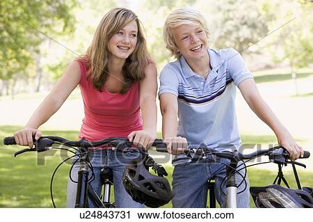 Teenage Boy And Girl On Bicycles View Large Photo Image Stock Image - Teenage Boy And Girl On Bicycles. Fotosearch