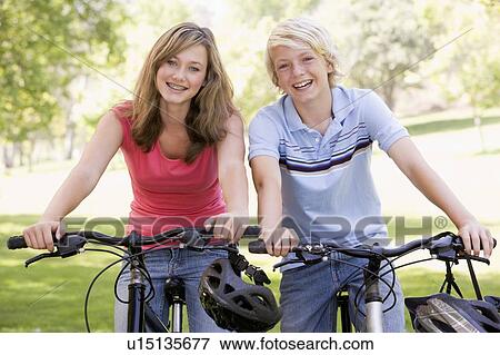 Teenage Boy And Girl On Bicycles View Large Photo Image Stock Photo - Teenage Boy And Girl On Bicycles. Fotosearch