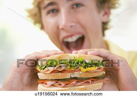 Teenage Boy Eating Sandwich View Large Photo Image Picture - Teenage Boy Eating Sandwich. Fotosearch
