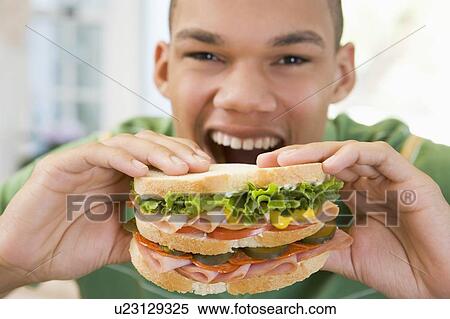 Teenage Boy Eating Sandwich View Large Photo Image Stock Photography - Teenage Boy Eating Sandwich. Fotosearch
