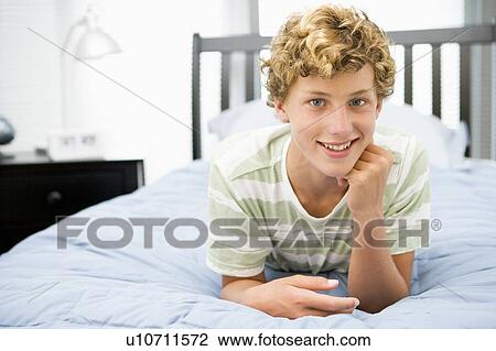 Teenage Boy Lying On Bed View Large Photo Image Stock Image - Teenage Boy Lying On Bed. Fotosearch
