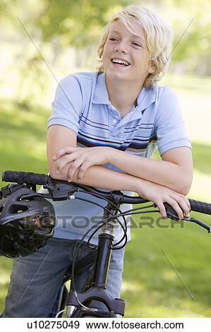 Stock Photo - Teenage Boy On Bicycle. Fotosearch