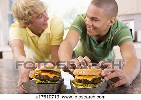 Teenage Boys Eating Burgers View Large Photo Image Stock Photo - Teenage Boys Eating Burgers . Fotosearch