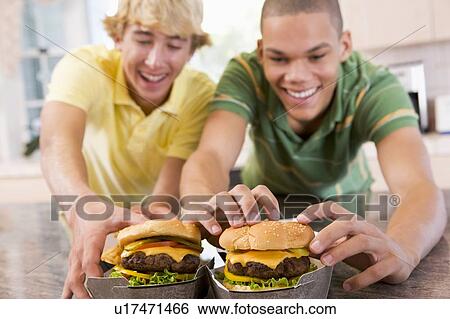 Teenage Boys Eating Burgers View Large Photo Image Stock Photograph - Teenage Boys Eating Burgers. Fotosearch
