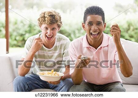 Teenage Boys Sitting On Couch Together View Large Photo Image Stock Photograph - Teenage Boys Sitting On Couch Together . Fotosearch