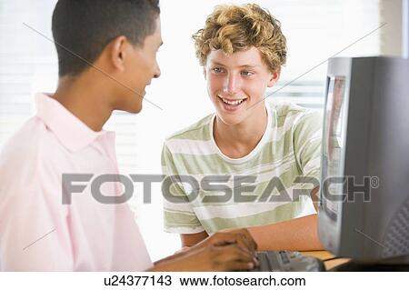 Stock Image - Teenage Boys Using Desktop Computer . Fotosearch