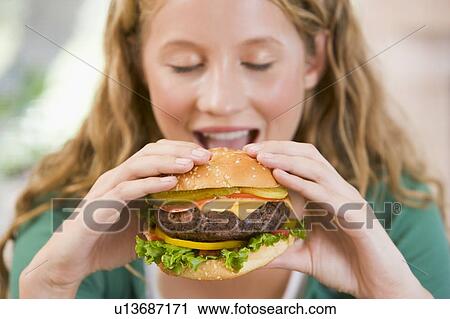Teenage Girl Eating Burgers View Large Photo Image Stock Image - Teenage Girl Eating Burgers . Fotosearch