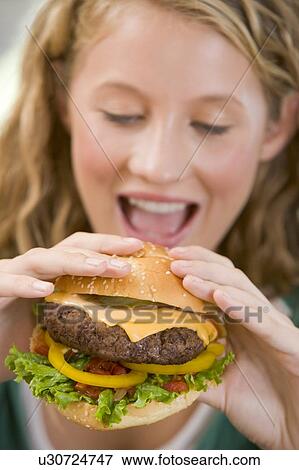 Teenage Girl Eating Burgers View Large Photo Image Stock Photo - Teenage Girl Eating Burgers . Fotosearch