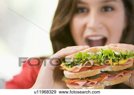 Stock Photo - Teenage Girl Eating Sandwich . Fotosearch