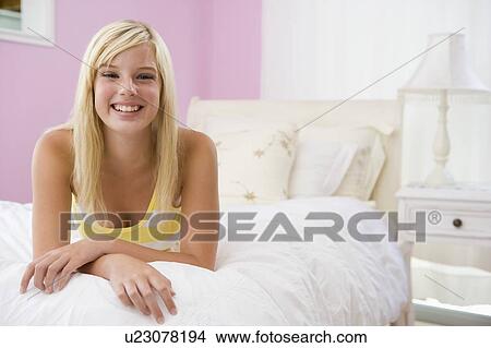 Picture - Teenage Girl Lying On Bed. Fotosearch