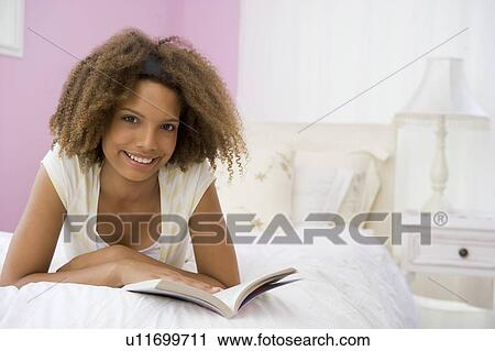 Teenage Girl Lying On Bed Reading View Large Photo Image Stock Image - Teenage Girl Lying On Bed Reading. Fotosearch