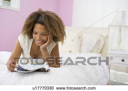 Teenage Girl Lying On Bed Reading View Large Photo Image Stock Image - Teenage Girl Lying On Bed Reading. Fotosearch
