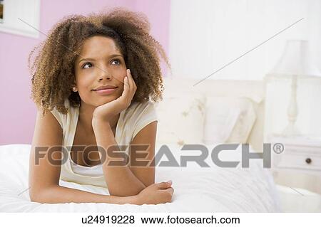 Stock Photo - Teenage Girl Lying On Bed. Fotosearch