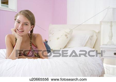 Stock Photograph - Teenage Girl Lying On Bed. Fotosearch