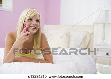 Teenage Girl Lying On Bed Using Mobile Phone View Large Photo Image Stock Image - Teenage Girl Lying On Bed Using Mobile Phone . Fotosearch