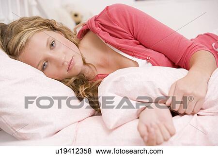 Teenage Girl Lying On Her Bed Looking Sick View Large Photo Image Stock Photo - Teenage Girl Lying On Her Bed Looking Sick . Fotosearch