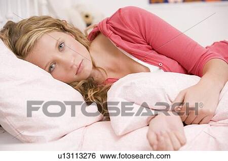 Teenage Girl Lying On Her Bed Looking Sick View Large Photo Image Stock Photograph - Teenage Girl Lying On Her Bed Looking Sick . Fotosearch
