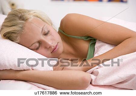 Stock Photograph - Teenage Girl Lying On Her Bed . Fotosearch