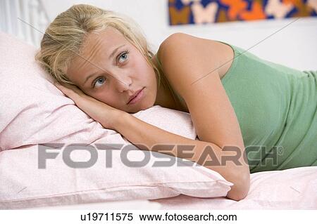 Stock Photography - Teenage Girl Lying On Her Bed . Fotosearch