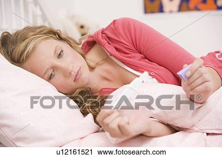 Teenage Girl Lying On Her Bed With A Pregnancy Test View Large Photo Image Stock Image - Teenage Girl Lying On Her Bed With A Pregnancy Test. Fotosearch