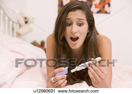 Teenage Girl Lying On Her Bed With A Pregnancy Test View Large Photo Image Stock Image - Teenage Girl Lying On Her Bed With A Pregnancy Test. Fotosearch