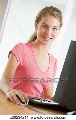 Stock Image - Teenage Girl Using Desktop Computer . Fotosearch