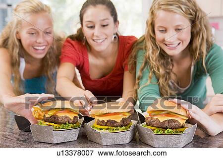 Teenage Girls Eating Burgers View Large Photo Image Stock Photo - Teenage Girls Eating Burgers . Fotosearch