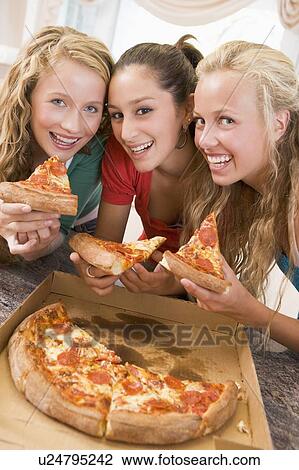 Stock Image - Teenage Girls Eating Pizza . Fotosearch