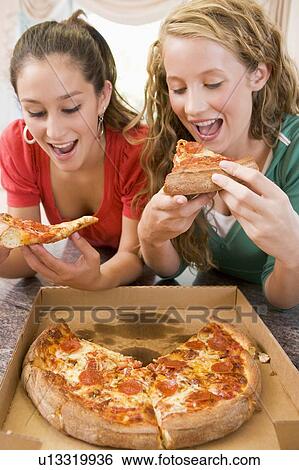Stock Photograph - Teenage Girls Eating Pizza . Fotosearch