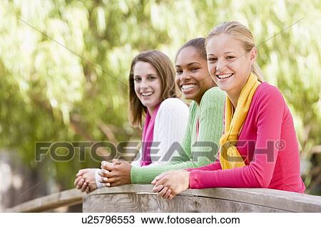 Teenage Girls Leaning On Wooden Railing View Large Photo Image Stock Image - Teenage Girls Leaning On Wooden Railing. Fotosearch