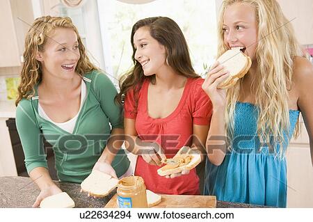 Picture - Teenage Girls Making Sandwiches. Fotosearch