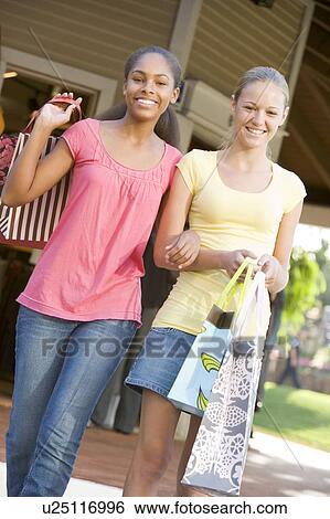 Stock Photograph - Teenage Girls Out Shopping . Fotosearch