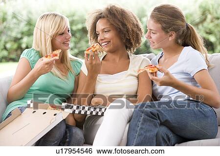 Teenage Girls Sitting On Couch And Eating Pizza Together View Large Photo Image Stock Photograph - Teenage Girls Sitting On Couch And Eating Pizza Together. Fotosearch