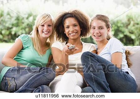 Stock Photograph - Teenage Girls Sitting On Couch . Fotosearch