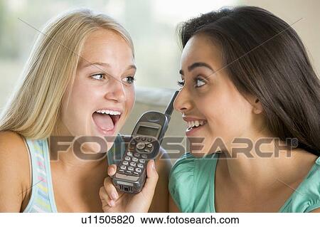 Stock Image - Teenage Girls Talking On Telephone . Fotosearch
