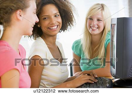 Stock Image - Teenage Girls Using Desktop Computer. Fotosearch