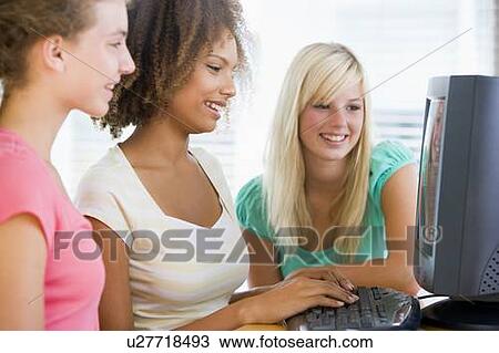 Stock Image - Teenage Girls Using Desktop Computer. Fotosearch