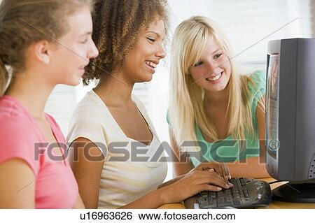 Stock Photograph - Teenage Girls Using Desktop Computer. Fotosearch