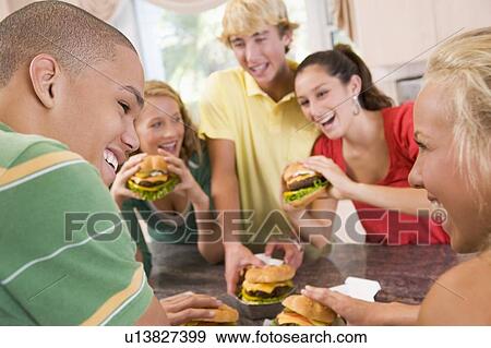 Teenagers Eating Burgers View Large Photo Image Stock Photo - Teenagers Eating Burgers. Fotosearch