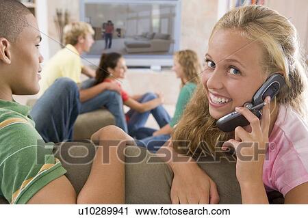 Teenagers Hanging Out In Front Of Television Using Mobile Phones View Large Photo Image Stock Image - Teenagers Hanging Out In Front Of Television Using Mobile Phones . Fotosearch