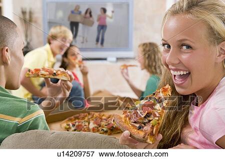 Teenagers Hanging Out In Front Of Television Eating Pizza View Large Photo Image Stock Photo - Teenagers Hanging Out In Front Of Television Eating Pizza . Fotosearch