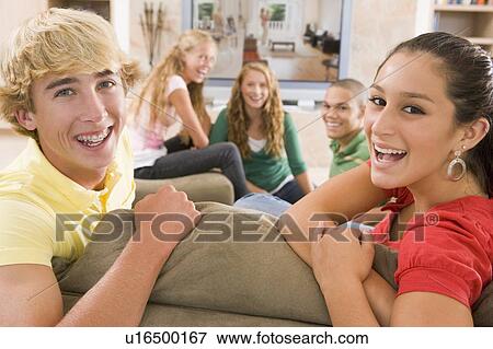 Stock Photo - Teenagers Hanging Out In Front Of Television . Fotosearch