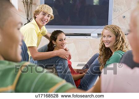 Teenagers Hanging Out In Front Of Television View Large Photo Image Stock Photo - Teenagers Hanging Out In Front Of Television . Fotosearch