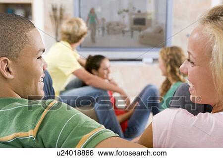 Teenagers Hanging Out In Front Of Television View Large Photo Image Stock Photograph - Teenagers Hanging Out In Front Of Television . Fotosearch