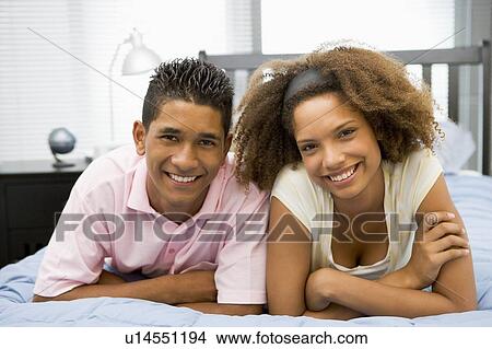 Picture - Teenagers Lying On Bed Together . Fotosearch