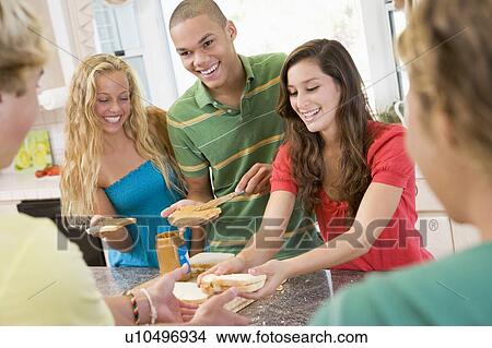 Picture - Teenagers Making Sandwiches. Fotosearch
