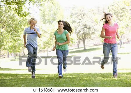 Teenagers Running Through Park View Large Photo Image Stock Image - Teenagers Running Through Park. Fotosearch