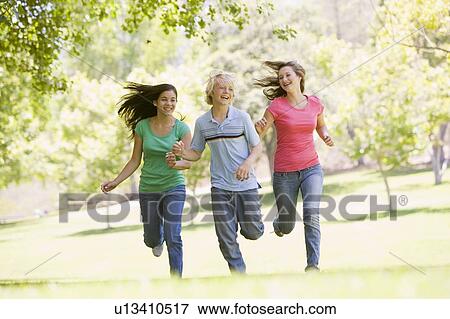 Teenagers Running Through Park View Large Photo Image Stock Photo - Teenagers Running Through Park. Fotosearch