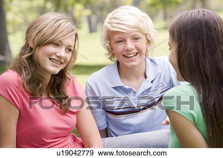 Stock Photo - Teenagers Sitting And Conversing. Fotosearch