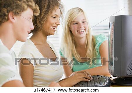 Teenagers Using Desktop Computer Together View Large Photo Image Stock Photo - Teenagers Using Desktop Computer Together. Fotosearch